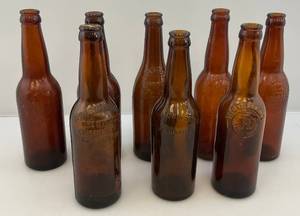 lot 135 image: Misc. Antique Embossed Amber Glass Beer Bottles
