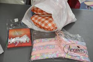 lot 27 image: Lot of Decorative Pillows, Hangers, Home Decor, and Calvin Klein Hoodies