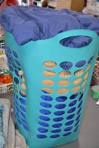 lot 73 image: Lot of Blue and Gray Bedding with Teal Laundry Basket