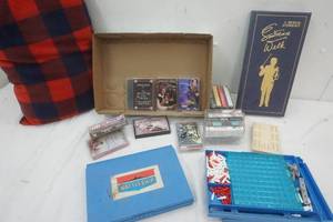 lot 45 image: Variety of Cassette Tapes, Lawrence Welk Musical Anthology 4 Cassette Tapes, Vintage Cribbage Board and Pieces, and Battleship Game, Pillow