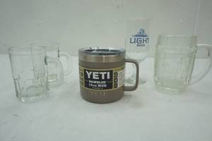 lot 210 image: Yeti 14 oz Rambler mug, 2 small mug, Dads Root bear mug and stem glass