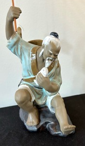 lot 61 image: Chinese Mudman Fisherman Figurine