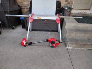 lot 171 image: Milwaukee Compact Vacuum (vacuum works, battery not included). Milwaukee collapsible saw stand. (RPD)