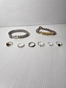 lot 251 image: Jewelry 2 cross rings, heart ring, state of MN ring, and two other rings. Two chain bracelets