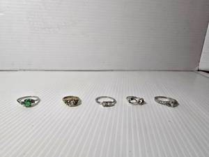 lot 256 image: 5 rings. Eternity symbol ring has diamond in it