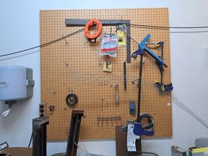 lot 187 image: Peg Board with Peg Board Hooks, Contents - Hand Tools - Square, Irwin Clampss, Fish Tape, Misc. Tools and Hardware