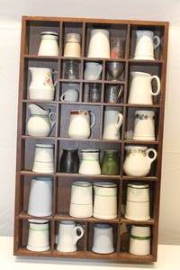 lot 72 image: Lot of 30 Small Assorted Pitchers and Glass Collectibles in Wooden Display