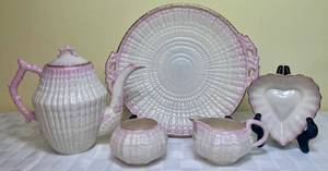 lot 120 image: Belleek Ireland Pink & Gilded Heart Bowl, Pink Tridacna Porcelain Creamer, Pink Tridacna Open Sugar Bowl, Pink Tridacna Serving Plate and 8 Teapot