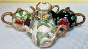 lot 16 image: Vintage Fitz and Floyd Midnight Rose Teapot, Asian Lily Teapot, Calla Lily Teapot and Fruit Fait Teapot