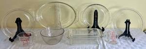 lot 55 image: Vintage PYREX Clear Glass Bundle plus 50 Years Fire King Pie Plate. Includes Loaf Pan with Lid, Pie Plates, Measuring Cups, Bowl and Casserole Dish.