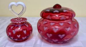 lot 79 image: Fenton Art Glass 1998 Heart Optic Covered Jar and Cranberry Heart Optic Perfume Bottle with Stopper