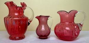 lot 165 image: Victorian Hand Blown Cranberry Ruffled Rim Hand Painted 9 Pitcher, Pinch Top Hand Blown Quilted Pattern Cranberry 6 Pitcher and 7 Cranberry Glass Pitcher