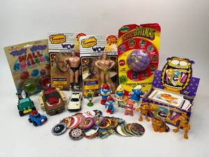 lot 99 image: Vintage Toy Lot - Transformers, WCW Wrestling Figures, Madballs, Garfield, Smurfs, Pogs
