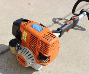 lot 32 image: STIHL Model # FS 90 R, Gas Powered Straight Shaft Professional String Trimmer