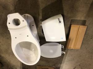 lot 34 image: Delta Foundations 2-Piece 1.28 GPF Single Flush Elongated Toilet in White  Customer Returns See Pictures