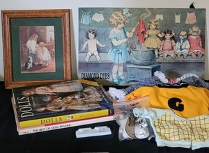 lot 16 image: Tin Litho Diamond Dyes a Busy Day in Dollville, Doll Collector Books, misc.