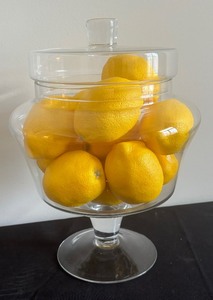 lot 207 image: Two Decorative Glass Cloches and Decorative Glass Covered Pedestal Bowl with Faux Lemons