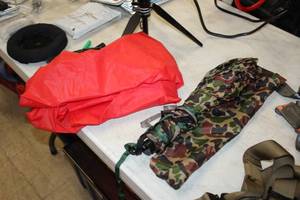 lot 412 image: Camo Umbrella with Case, Orange Rain Poncho