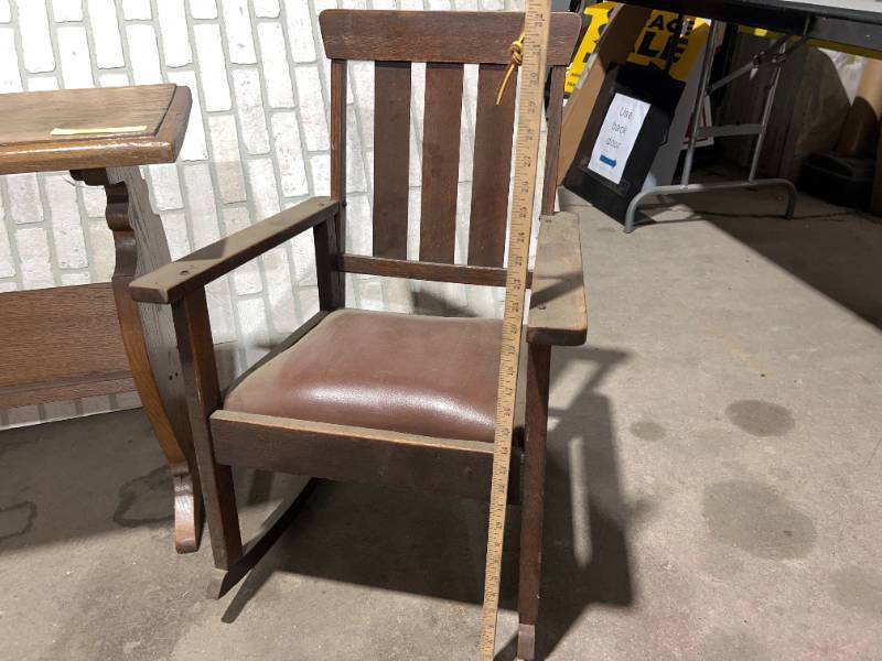 lot 1382 image: ANTIQUE WOOD CUSHION ROCK CHAIR, CRADEL, BOOK TABLE, WOOD SLED, METAL DECORATIVE SLED LOT