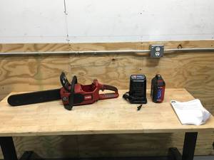 lot 131 image: Used Toro 60V MAX 16 in. Brushless Chainsaw with 2.5Ah battery and charger Model # 51850 (Tested And Works)