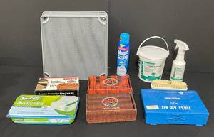 lot 99 image: Cleaning and Care Lot - Oreck Dry Carpet Cleaner Supplies (Used), VTG First Aid Kit, Wood Care Kit, Fabric Care Kit, Swiffer Sweeper Pads (unopened), Leather Protection Plan Care Kit and Mesh Metal Racking Parts