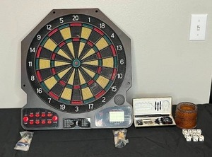 lot 137 image: Electronic Dartboard (untested) with Harley Davidson Darts, Mini J.Giambi Bobbleheads, Dice w Leather Cup & Engraved Fish