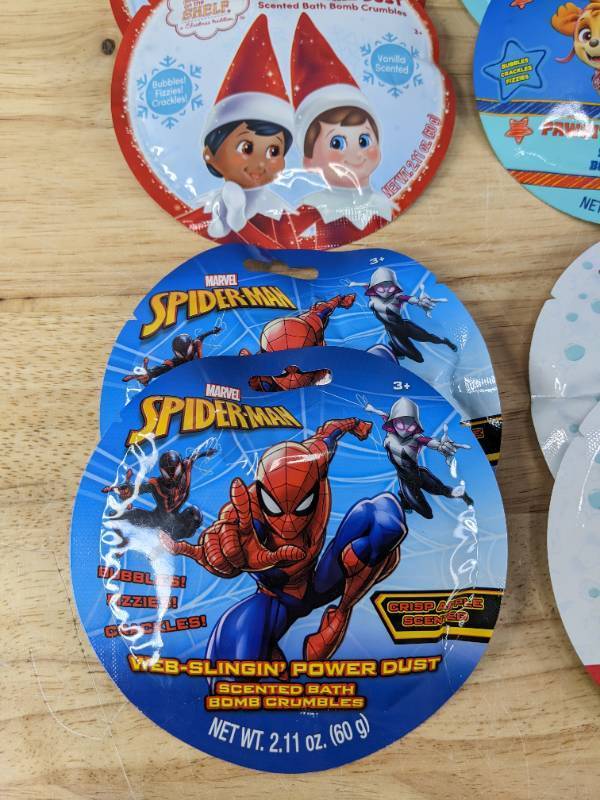 lot 45 image: (12) Brand New Scented Bath Bomb Crumbles Spiderman, Elf on a Shelf, Paw Patrol, Cocomelon, That Girl, LOL Surprise N