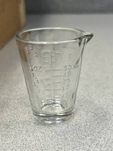 lot 19 image: 89 - 1oz. Medicine Glass Measuring Cups