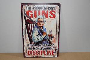 lot 52 image: Metal Sign The Problem Isnt Guns