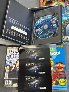 lot 83 image: T and E PC Game Lot including Star Trek Online Collectors Edition, Harry Potter and The Sorcerers Stone, The Office, Zoo Tycoon, Curse of Atlantis (New), EA Sports Collection (New), and More