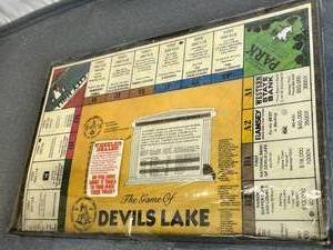 lot 165 image: Rare Vintage The Game of Devils Lake Ramsey County North Dakota Monopoly Game (Sealed with some Package Wear)