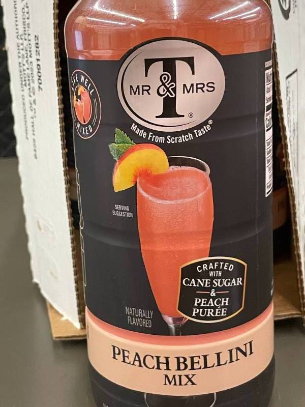 lot 24 image: Mr & Mrs T Peach Bellini Mix - 6 Pack of 1L Bottles