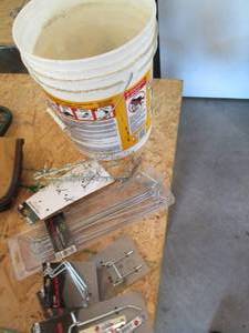 lot 55 image: Bucket filled with new and used peg...