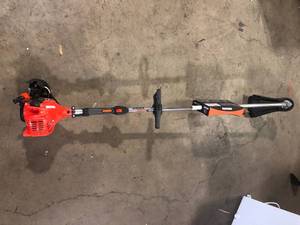 lot 39 image: ECHO 21.2 cc Gas 2-Stroke Straight Shaft String Trimmer  Broken Customer Returns See Pictures