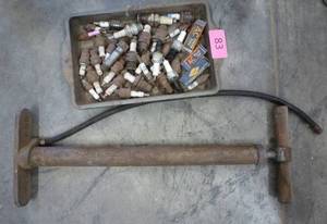 Vintage Ford pump and pan of old spark plugs some new