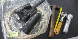 Dog tie out cable, flashlights, grill brush, hammer, wrench