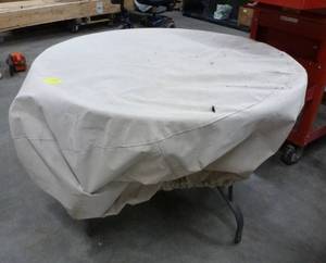 Patio table with cover, has center hole for an umbrella