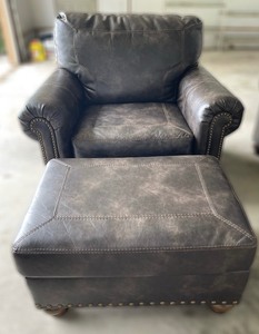 lot 307 image: Ashley Furniture Faux Leather with Nail head Trim Chair and Ottoman