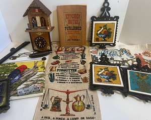 lot 424 image: WeatherCuckoo Style Clock (parts) Cast Iron Trivets and Linen Tea Towels