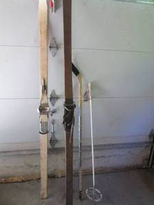 lot 13 image: Antique non-matching Cross Country snow skis.. One ski is from WWII while the darker ski is from the 1800s