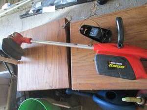 lot 22 image: Black and Decker CST1000 cordless weed whip with battery and charger