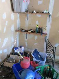 lot 32 image: Corner of assorted garage goodies to include a portable metal framed bike rack, misc motor oils, gas can, storage totes, roof melt, yard and camping supplies plus more