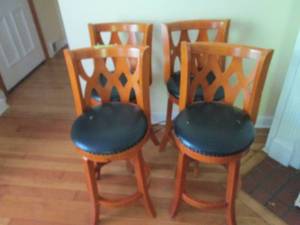 lot 41 image: Set of 4- well built Wood framed Swiveling stools with pleather and nail head adorned padded seats