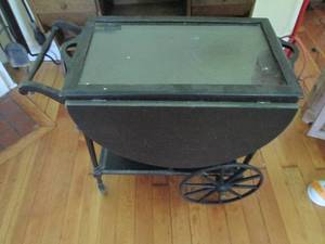 lot 45 image: Dark Tone wood butlers cart with removable glass tray top and drop leaf on each side wheels will need to be secured onto structure