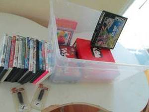 lot 51 image: Storage bin containing an assortment of child and family oriented DVDs and games