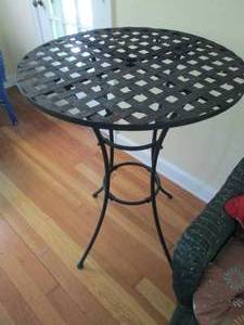lot 66 image: Counter height metal framed patio table with criss cross pattern top