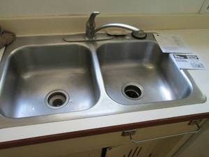lot 69 image: Stainless steel dual basin Kitchen sink, faucet and garbage disposal buyer responsible to bring proper tools and remove from structure