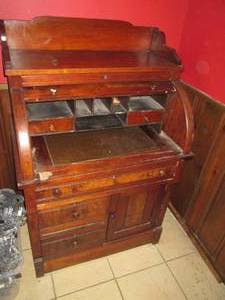 lot 5 image: Antique solid wood roll top secretary desk with pull out surface, drawers, doors and sectionalized compartments
