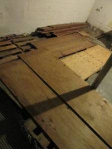 lot 84 image: All plywood sections and other lumber in basement take what you want, leave what you dont