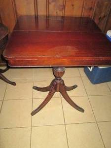 lot 87 image: Columbia Clawfoot style dining table with top fold-up and revolving surface with one side lifts at specific position to reveal a secret storage compartment